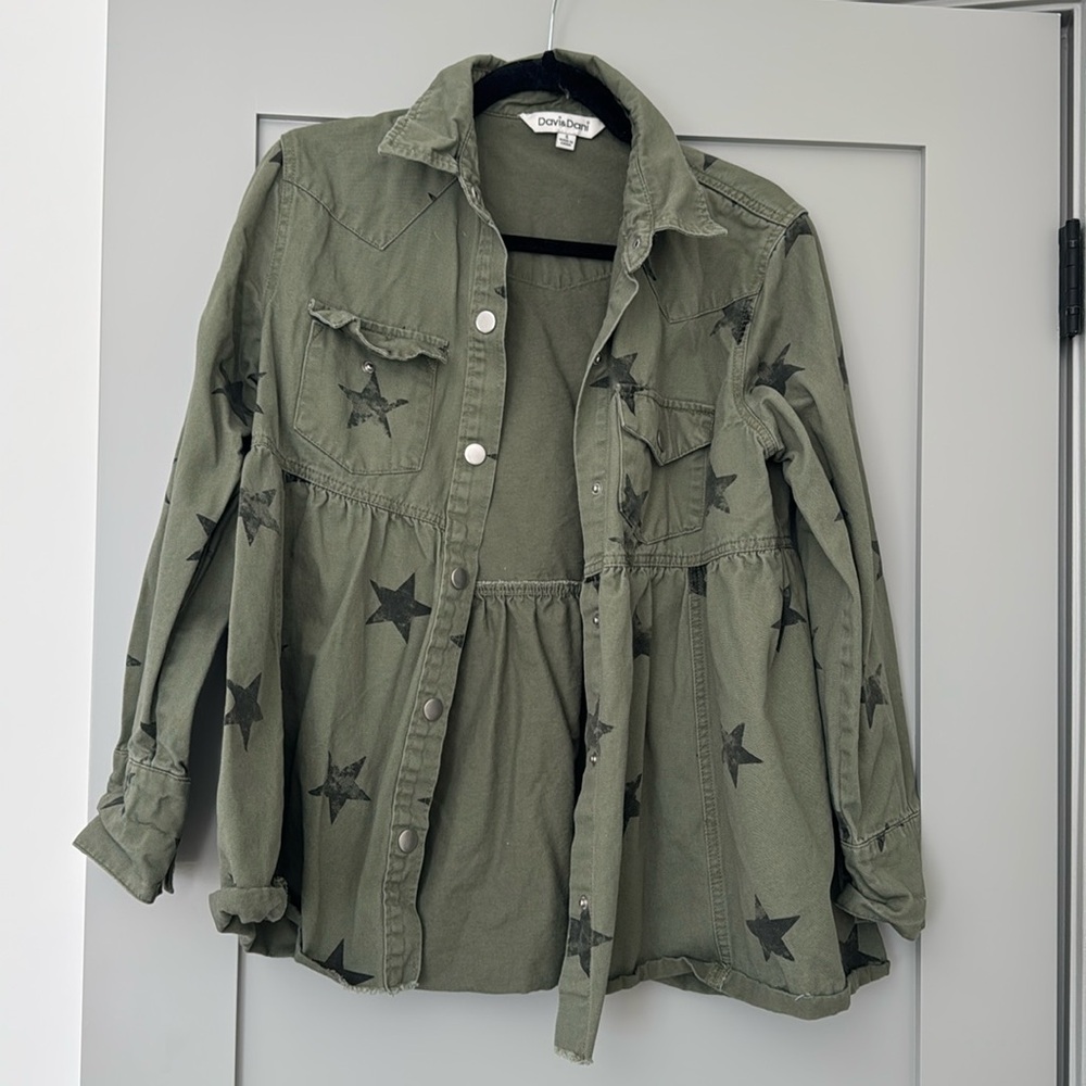 Peplum style utility jacket with black stars.